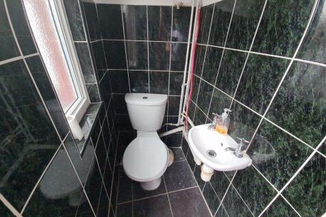 A well-maintained bathroom featuring a toilet a...