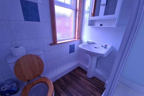 A bright and clean bathroom featuring a classic...