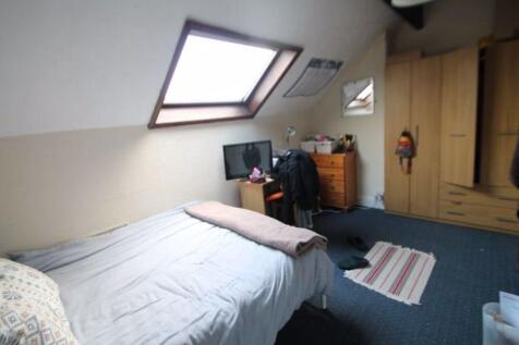 A cozy bedroom illuminated by natural light fro...