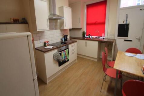A bright and tidy kitchen with modern cabinets ...