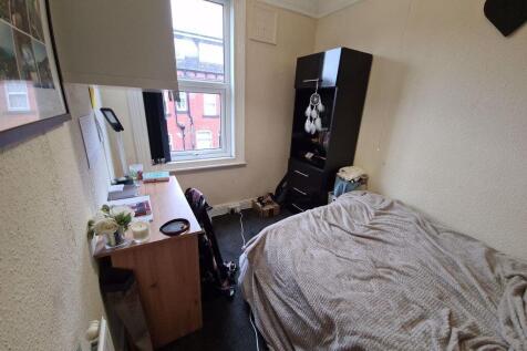 A cozy bedroom with a comfortable bed, a study ...