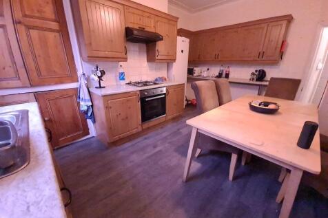 A well-maintained kitchen with wooden cabinets,...