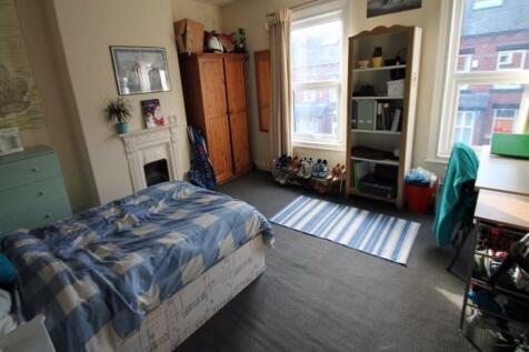 A cozy, well-lit bedroom with a single bed, nat...