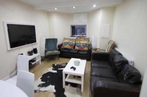 A cozy and well-lit living room featuring comfo...