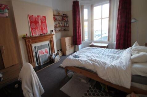 A bright and tidy bedroom featuring a comfortab...