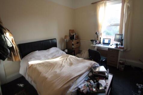 A cozy bedroom featuring a double bed, a window...