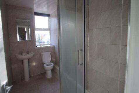 A clean and bright bathroom with a sink, toilet...