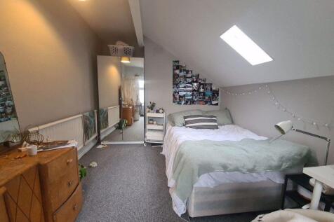 A bright and well-maintained bedroom featuring ...