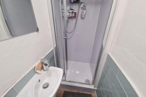 A clean and modern bathroom featuring a glass s...