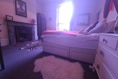 A spacious and well-maintained bedroom featurin...