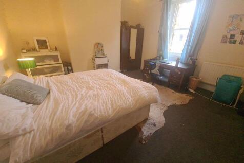 A spacious and inviting master bedroom featurin...