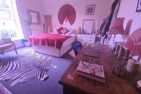 A spacious and well-lit living room with stylis...