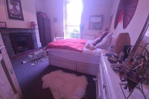 A cozy master bedroom featuring a comfortable d...