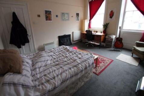 A cozy bedroom featuring a double bed with a co...