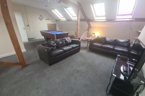 A bright and inviting living room with ample na...