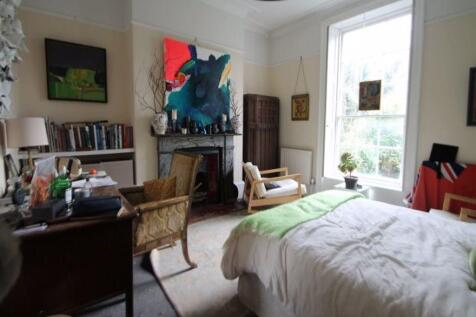 A bright, cozy bedroom with a comfortable bed, ...