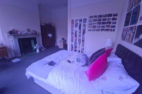 A cozy bedroom featuring a comfortable bed with...