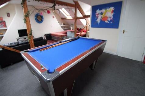 A well-lit, contemporary living room featuring ...