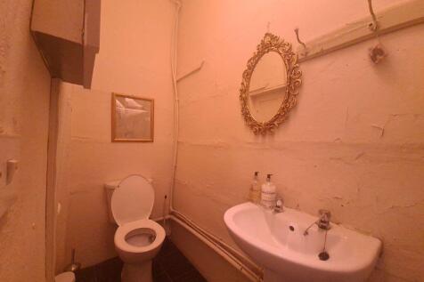 A well-maintained bathroom with a toilet and si...