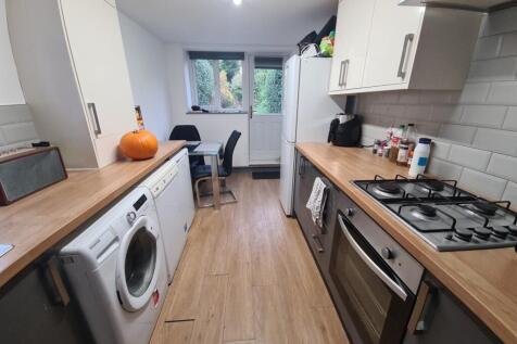 A modern, bright kitchen with ample natural lig...