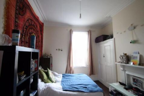 A spacious and well-lit master bedroom featurin...