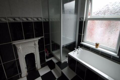 A modern bathroom featuring a bathtub next to a...