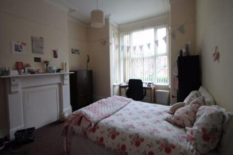 A cozy, well-maintained bedroom featuring a com...