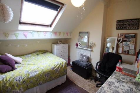 A cozy bedroom with a skylight window providing...