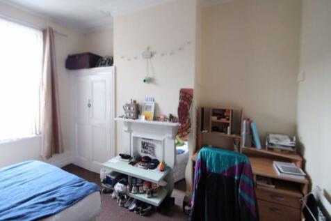 A cozy student bedroom featuring a single bed, ...