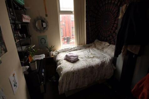 A cozy and well-maintained bedroom featuring a ...