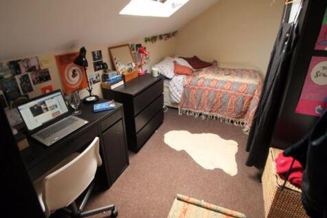 A cozy bedroom featuring a comfortable bed with...