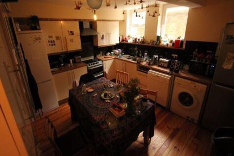 A cozy kitchen with a dining table, well-lit wi...