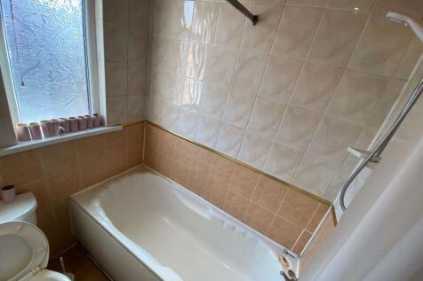 A spacious and well-maintained bathroom with a ...