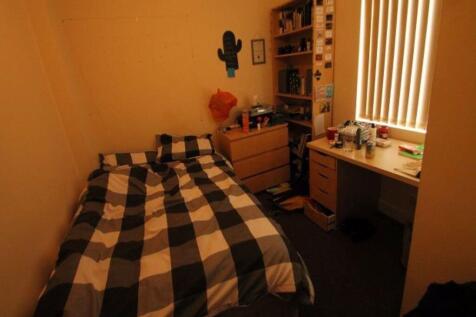 A cozy bedroom featuring a double bed, with a b...