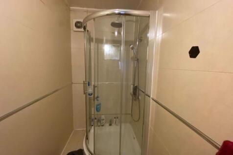 A clean and spacious bathroom with a large show...