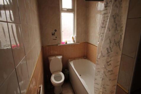 A well-maintained bathroom featuring a bathtub ...