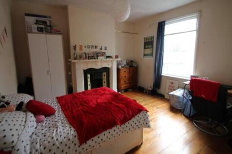 A bright and inviting bedroom featuring a doubl...