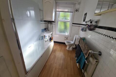 A clean and well-lit bathroom with basic amenit...