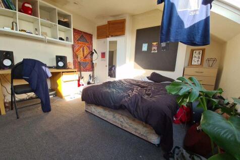 A spacious and well-lit master bedroom featurin...