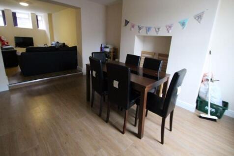 A spacious and bright living room featuring a m...