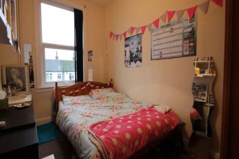 A comfortable double bedroom featuring a stylis...