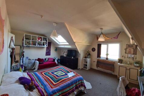 A cozy and well-maintained bedroom featuring a ...