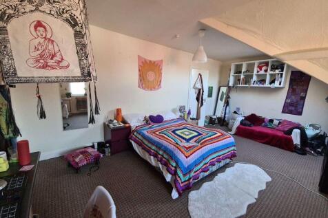 A bright and cheerful bedroom featuring a large...