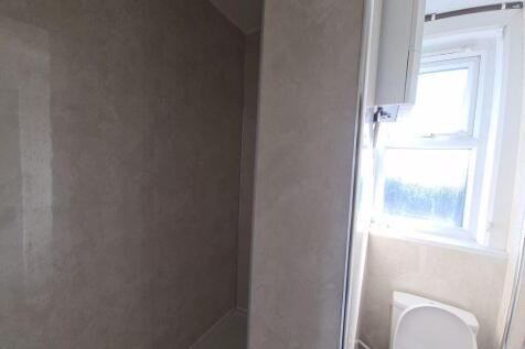 A bright and clean bathroom featuring a large w...