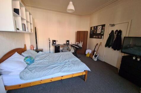 Spacious master bedroom featuring a double bed,...