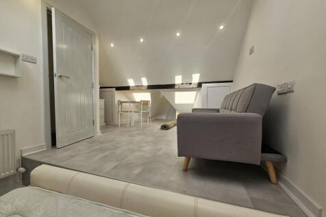 A modern and spacious living room featuring com...