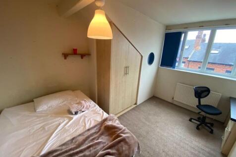Bright and tidy bedroom with a comfortable bed,...