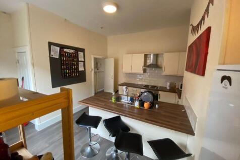 A modern, well-lit living room featuring a spac...