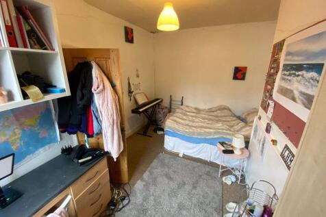 A cozy bedroom featuring a double bed, with a d...