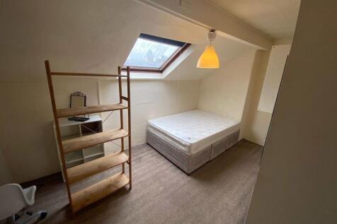 A small, tidy private bathroom area with a mode...